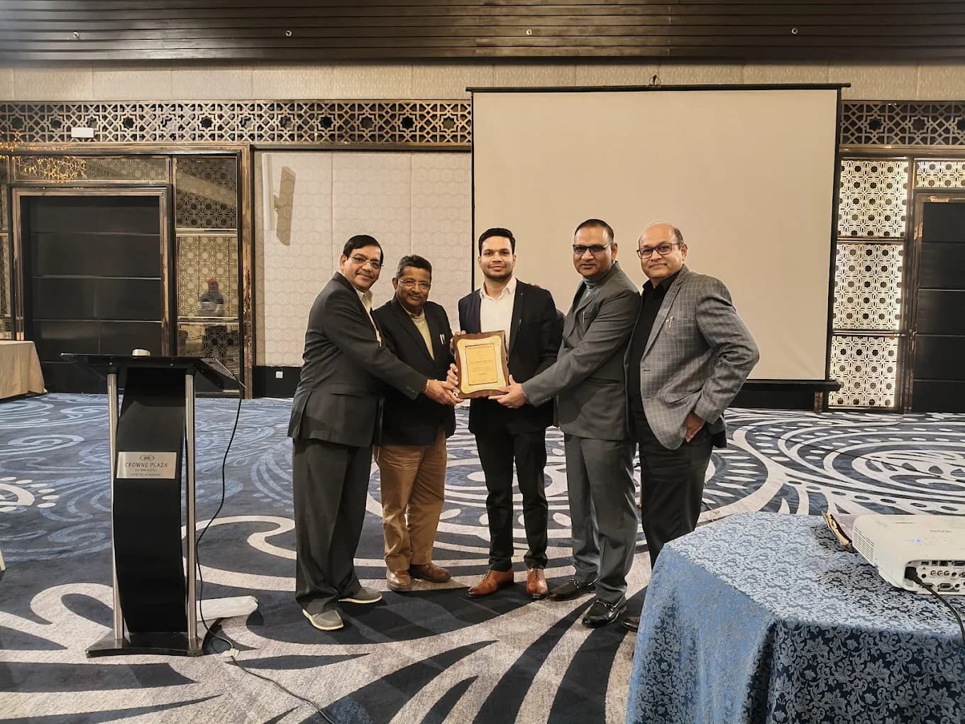 Dr. Pawan Goel receiving an award at a medical conference