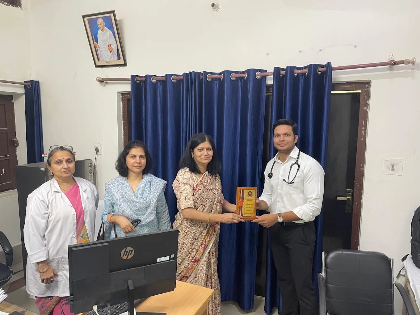 Dr. Pawan Goel receiving a hospital recognition award with colleagues