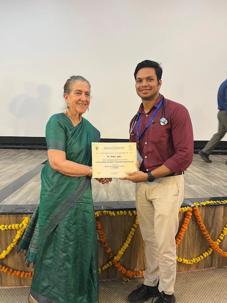Dr. Pawan Goel receiving a certificate at a medical conference